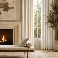 Cozy living room with fireplace, bench, and large window.