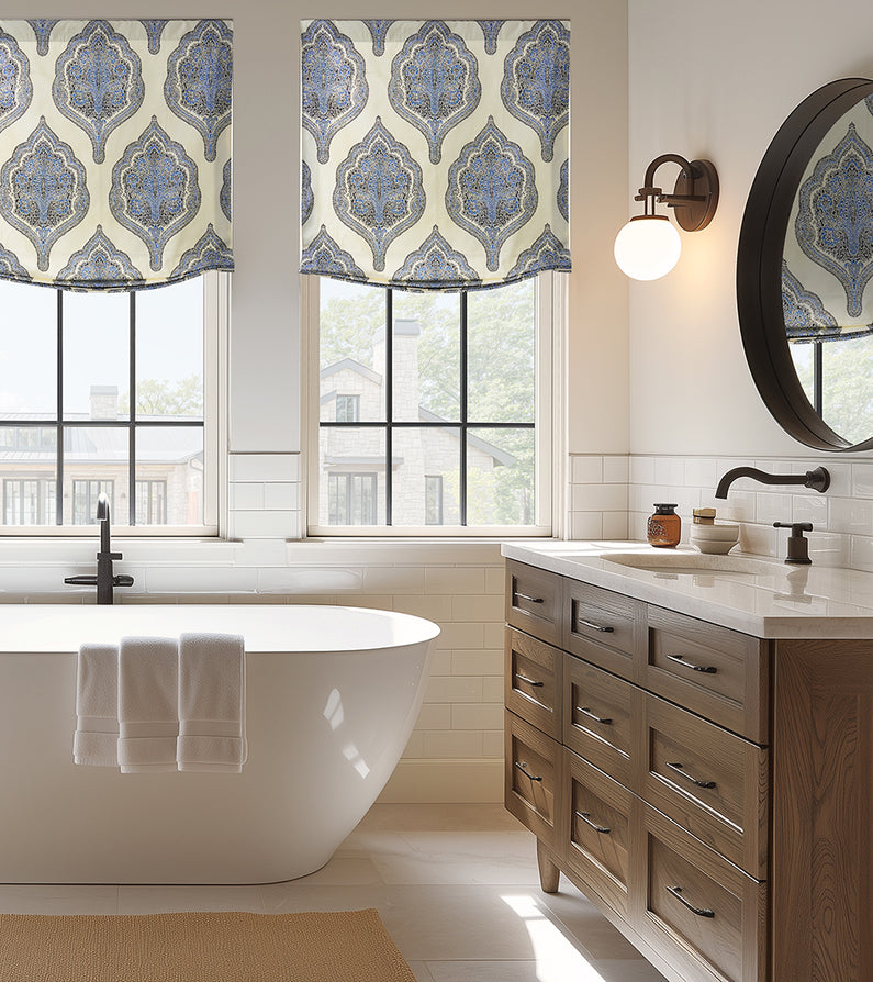 Arabesque Blue: Blue and ivory patterned Roman shades add an elegant decorative touch to three windows above a freestanding bathtub.