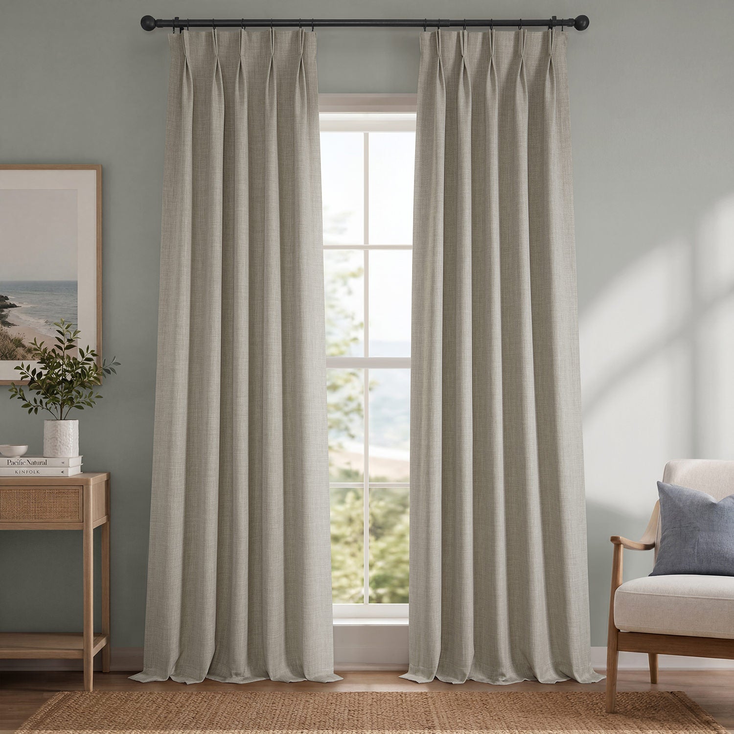 Light gray curtains hanging in a room with a window, side table, and chair.