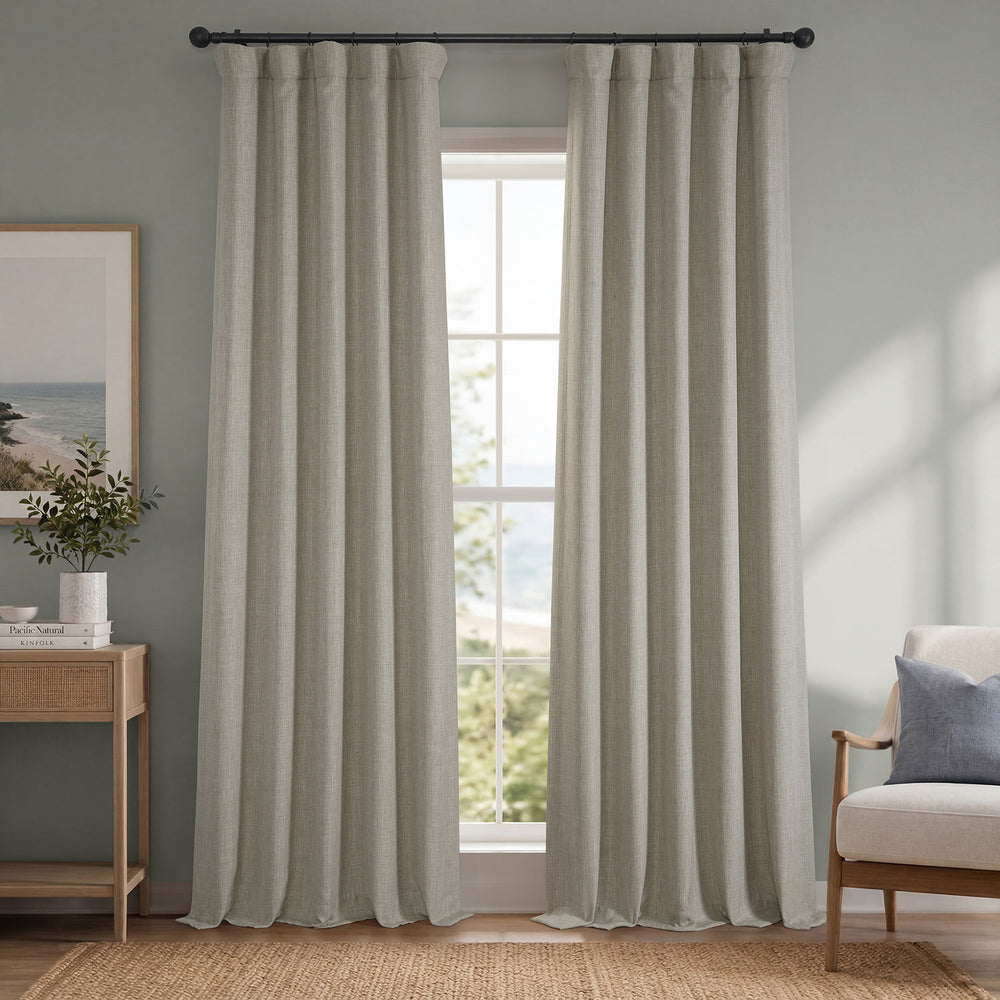 Living room with striped curtains, a chair, and a side table.