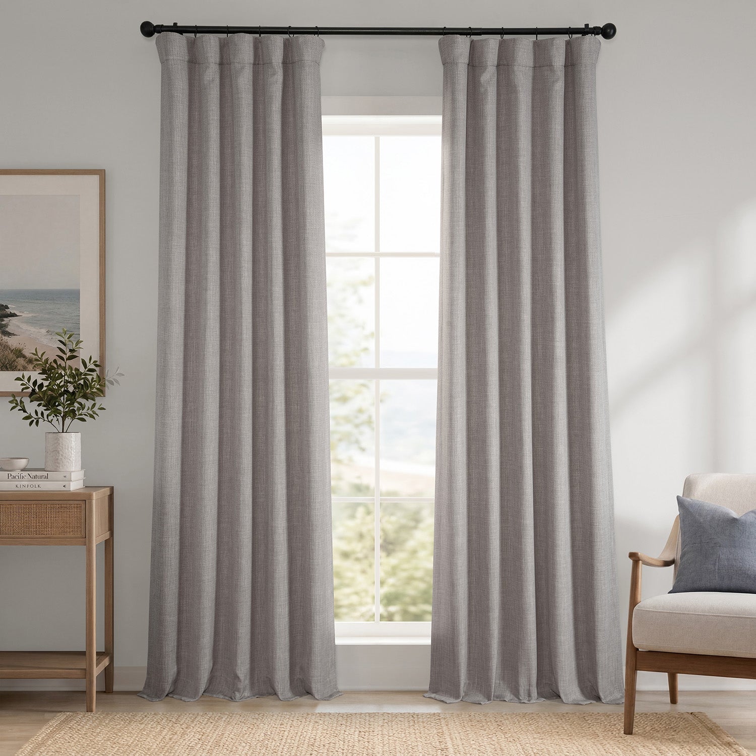 Gray striped curtains in a room with a window, side table, and chair.