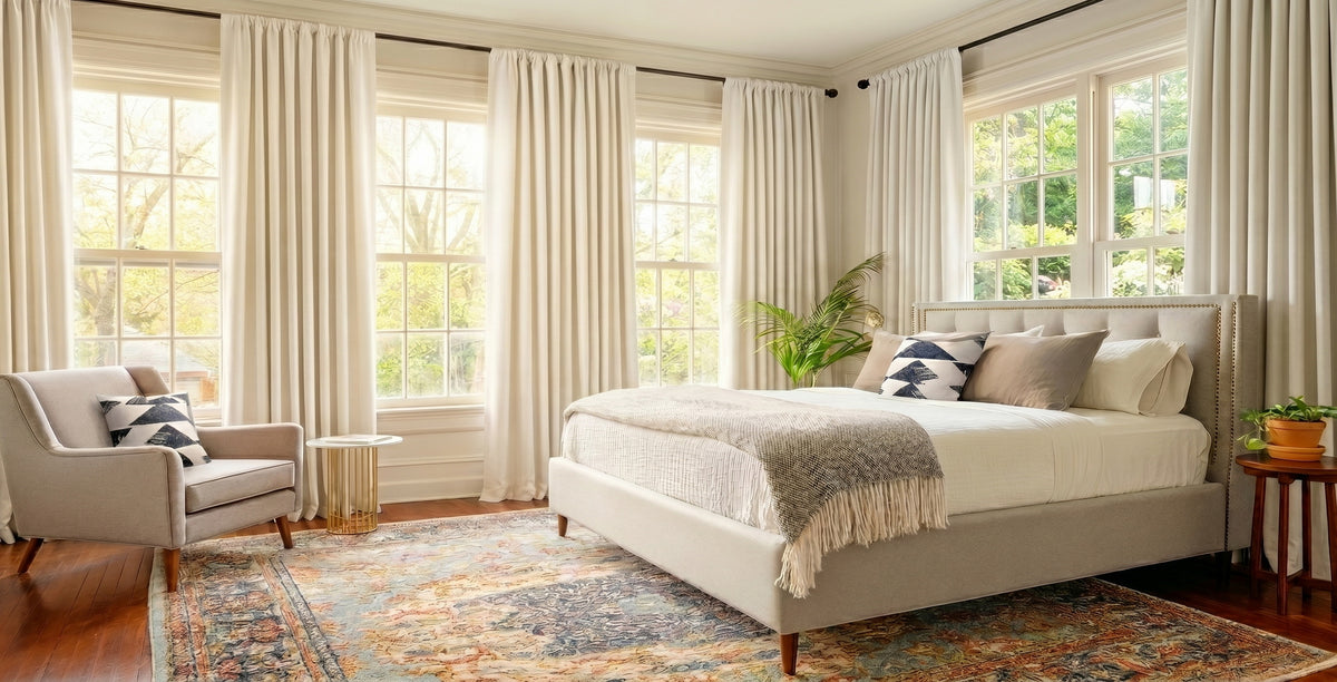 Extra wide ivory curtains covering expansive bedroom windows for larger spaces and enhanced coverage.