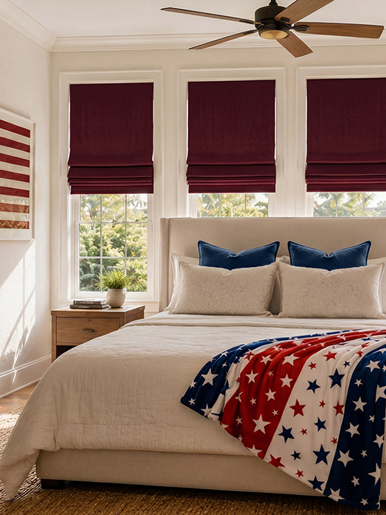 Burgundy Signature Velvet: Rich burgundy velvet Roman shades add bold color and luxurious texture to a bright bedroom.