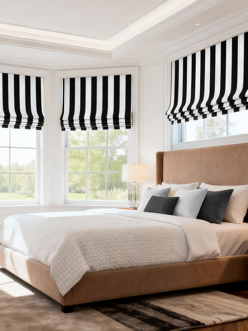 Cabana Black Striped Printed Cotton: Black and white striped Roman shades create a bold, graphic statement in a modern bedroom.