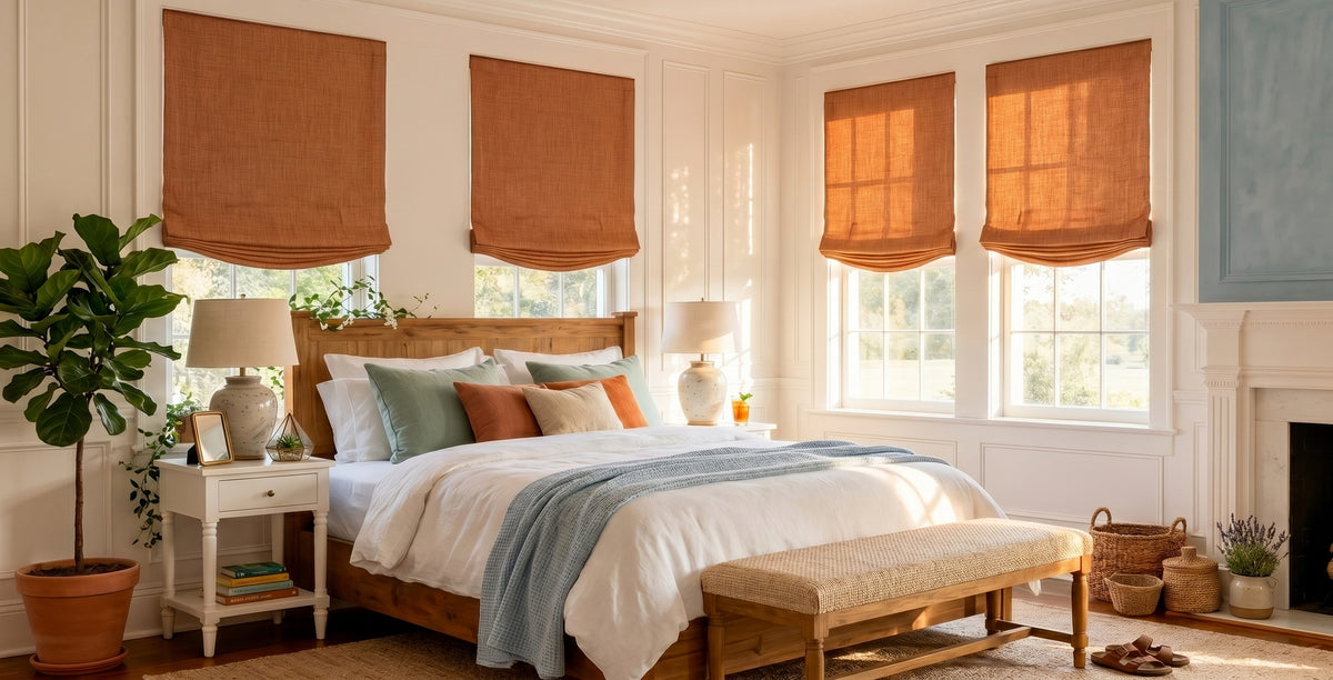 Desert Orange Textured Faux Linen Roman shades covering bedroom windows with a wood bed, fireplace, and warm natural light.