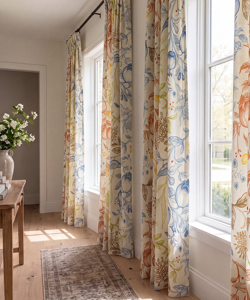 Humming Bird: Neutral linen-look curtains frame a wide living room window in a soft, inviting space with layered blush and brown accents.