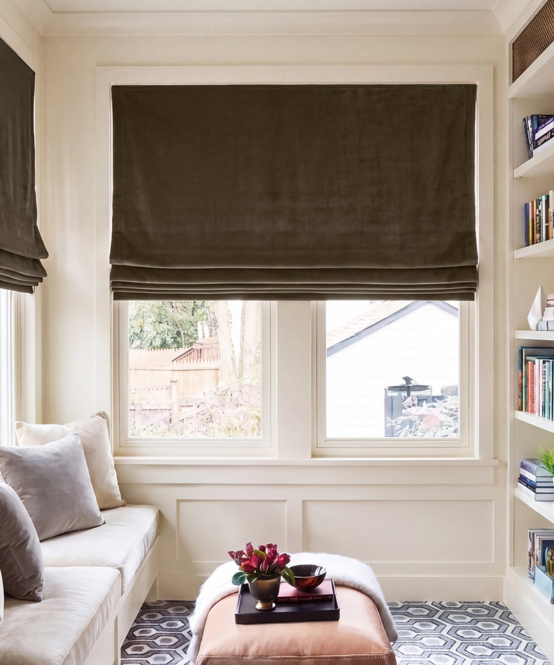 Java Signature Velvet: Rich brown velvet Roman shades add warmth and contrast to black-framed windows in an elegant, light-filled living room.