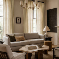 Living room with beige sofa, wooden coffee table, and decorative items.