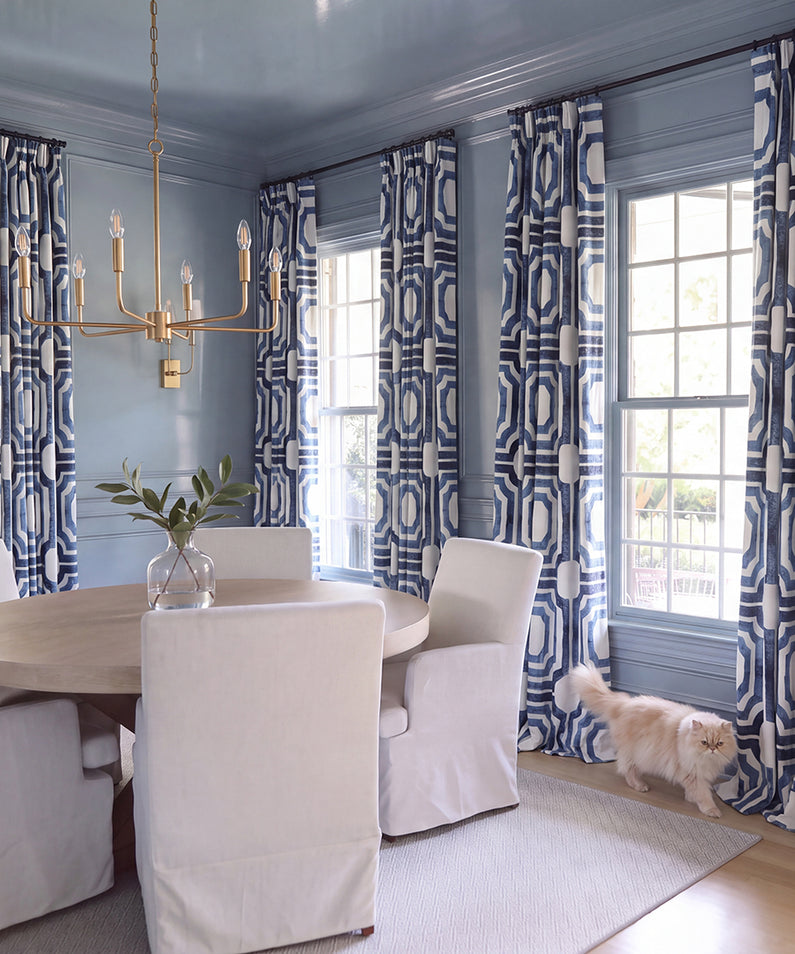 Indonesian Blue: Ornate blue-and-white patterned curtains add timeless character and striking contrast to this sophisticated living room.