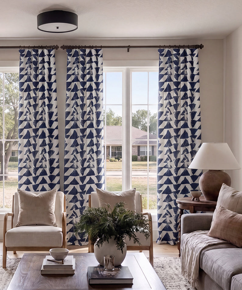 Indonesian Blue: Ornate blue-and-white patterned curtains add timeless character and striking contrast to this sophisticated living room.