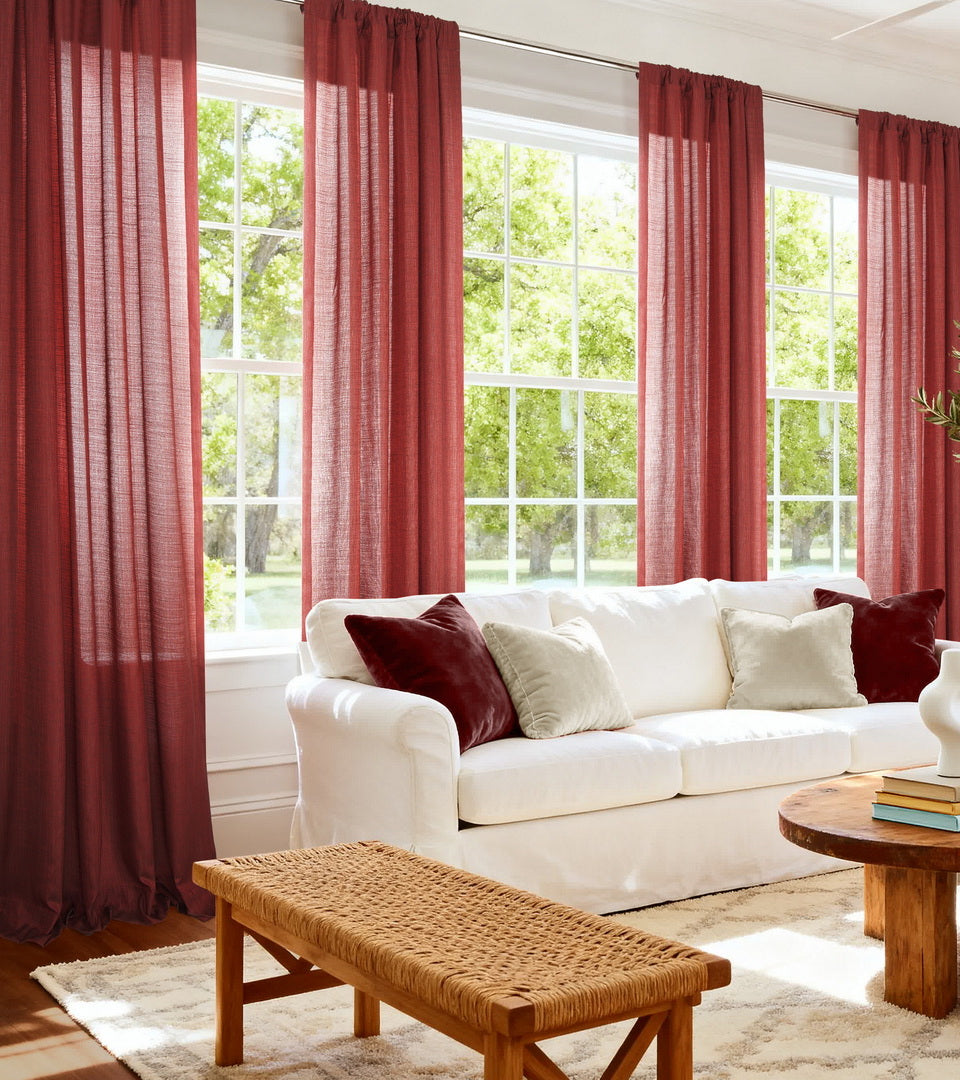 Rich red cotton curtains bring warmth and bold character to this light-filled living room. Their airy woven texture softly filters sunlight while the vibrant hue adds striking contrast to the crisp white furnishings and natural wood accents, creating a welcoming space with timeless style.