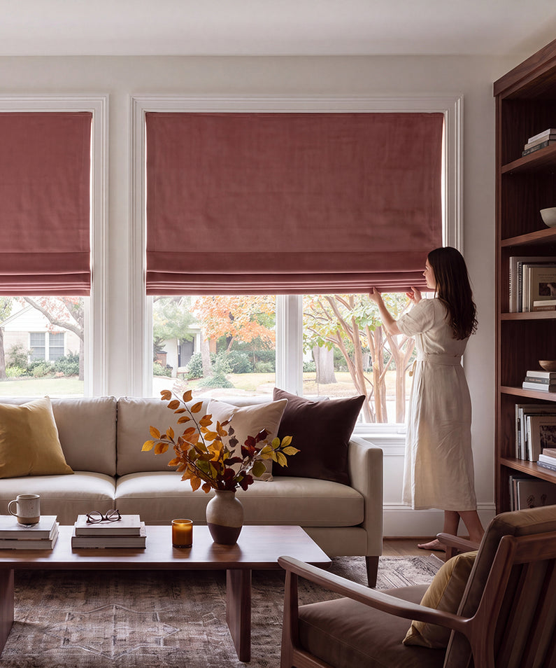 Wild Rose: Dusty rose Roman shades bring soft color and warmth to a bright bedroom with crisp white bedding and pastel accents.