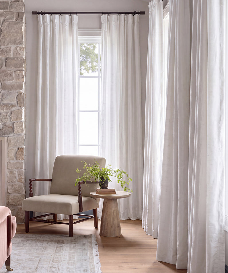 Vintage Dupioni: Crisp white curtains create a soft, light-filled backdrop for this fresh and serene living space.