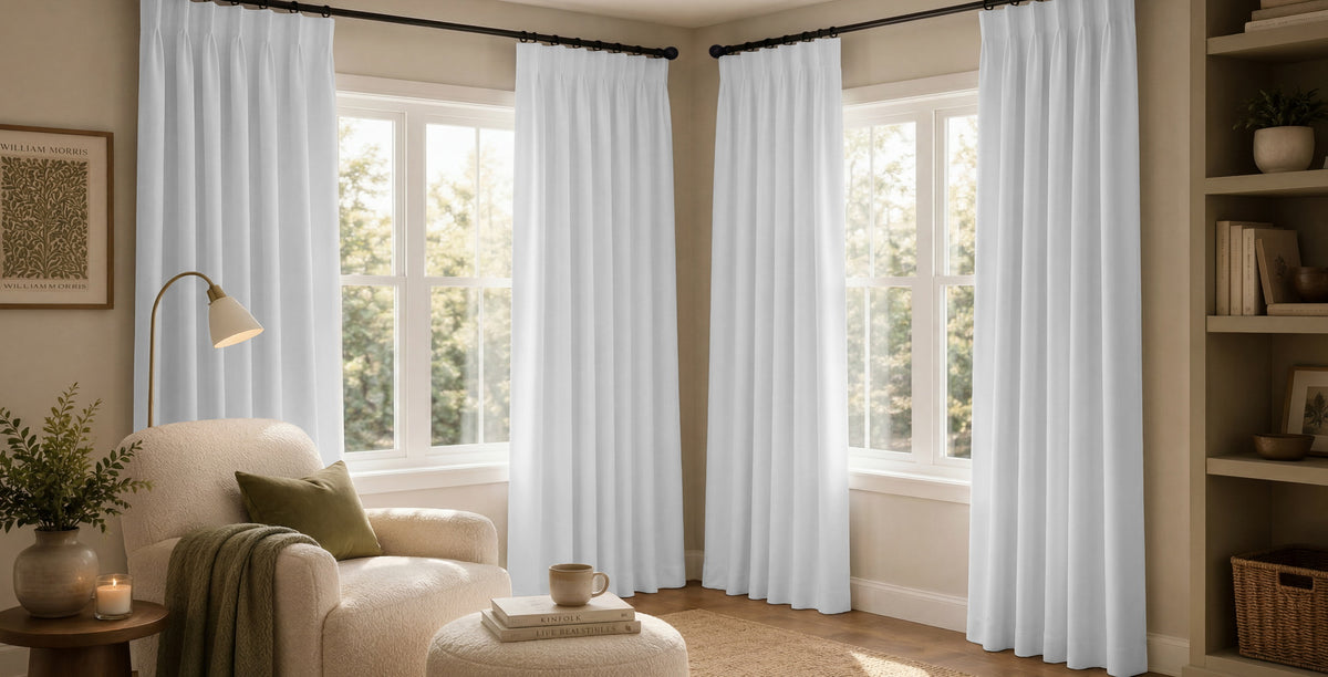 Bold indigo-and-white patterned curtains create a fresh statement in a bright, coastal-inspired living room.