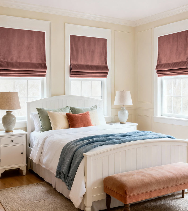 Wild Rose: Dusty rose Roman shades bring soft color and warmth to a bright bedroom with crisp white bedding and pastel accents.