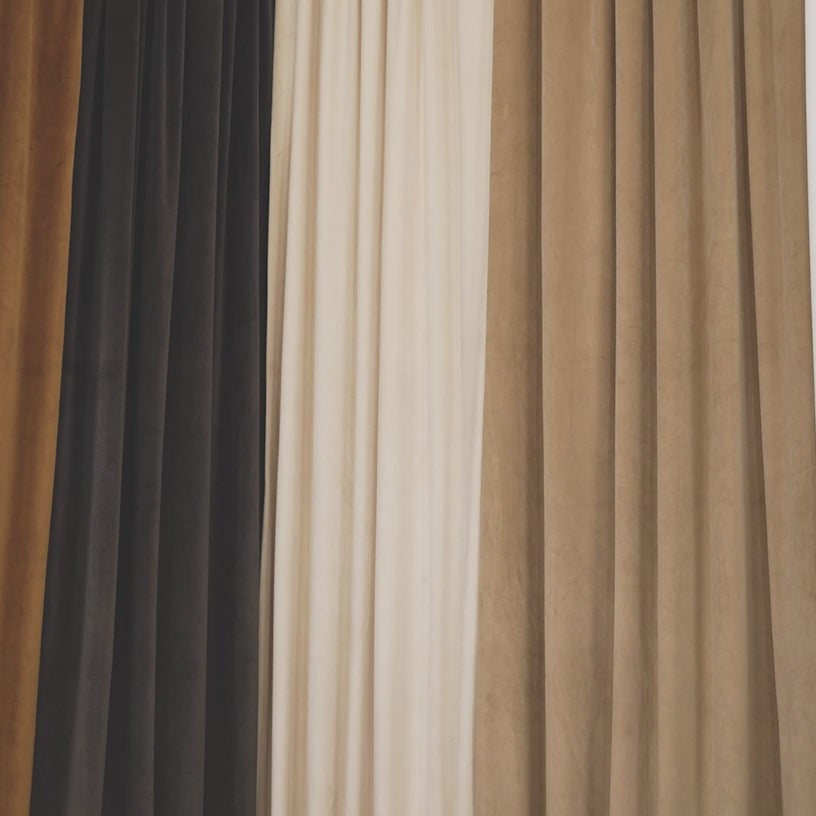 Heritage Plush Velvet Curtains styled in elegant, holiday-ready interiors. The video features living rooms and bedrooms with tall windows framed by rich velvet curtains in deep, saturated colors such as emerald green, ruby red, navy, and warm neutrals.