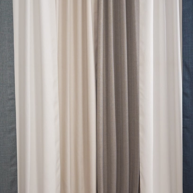 Italian faux linen curtains styled in bright, modern home interiors. The video features softly lit living rooms and bedrooms with tall windows dressed in light, textured linen-look drapes. Neutral color palettes dominate the scenes, including warm whites, soft beiges, and natural wood tones.