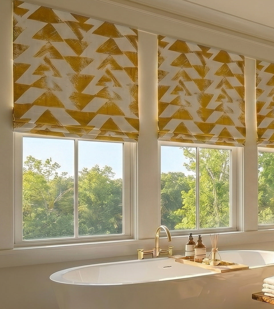 Patterned blackout roman shades blocking unwanted light in bathroom setting.